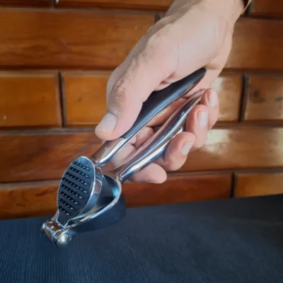 Stainless steel garlic press held in hand Durable Garlic Press – Easy Everyday Crushing