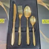 Close-up of AVD gold cutlery place setting in box