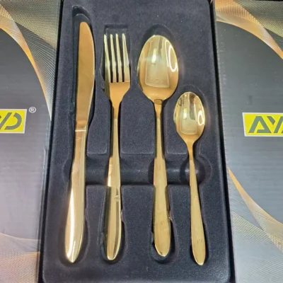 Close-up of AVD gold cutlery place setting in box