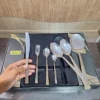 Hand holding AVD 36 piece cutlery set knife from place setting