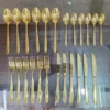 AVD 24 piece gold cutlery set full set laid out on table