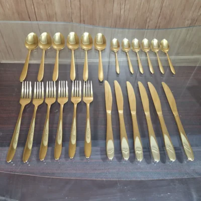 Overhead view of full AVD 24 piece gold cutlery set