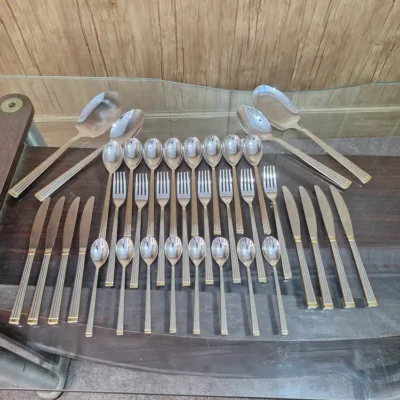 AVD 36 piece gold trimmed cutlery set full set laid out