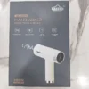 Uakeen ZL-2305 hand mixer cream-colored unit held in hand