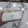 Uakeen Mini Steam Iron - Handle Button Detail Uakeen mini steam iron rose gold handle power button close-up