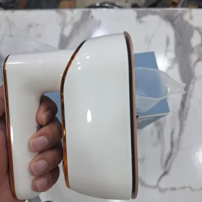 Uakeen ZL-227 folding travel iron underside held in hand